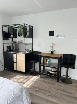 a bedroom with a desk and two chairs and a table at Nice and Cozy guest house 4 in Miami