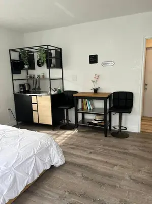 a bedroom with a desk and a table and chairs at Nice and Cozy guest house 4 in Miami