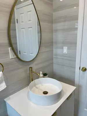 a bathroom with a white sink and a mirror at Nice and Cozy guest house 4 in Miami
