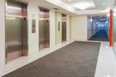 a hallway with elevators in a building with a carpet at Apt w/2 Queen Beds & Canal View at Tides in Hollywood
