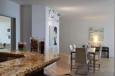 a kitchen and dining room with a table and chairs at 2Bed/2Bath, 4QueenBeds & OceanView at Tides in Hollywood
