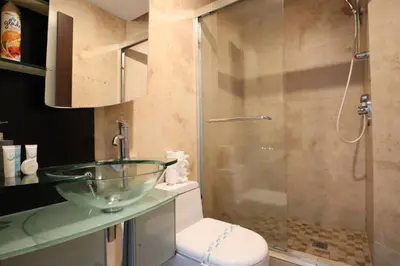 a bathroom with a glass bowl sink and a shower at 2Bed/2Bath, 4QueenBeds & OceanView at Tides in Hollywood