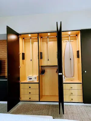 a bathroom with wooden cabinets and a microwave in it at Doral Pool 1107 by Wave Properties in Miami