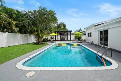 a swimming pool in the backyard of a house at Casa Mojito in Fort Lauderdale
