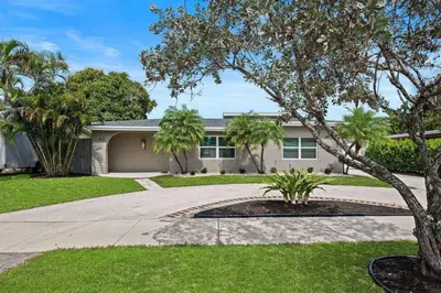 a house with palm trees and a driveway at Casa Mojito in Fort Lauderdale
