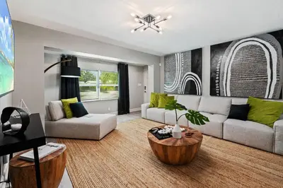 a living room with a couch and a table at Casa Mojito in Fort Lauderdale