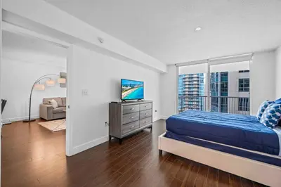 a bedroom with a bed and a television in it at Comfy 28th floor • Brickell • Ocean & City Views in Miami