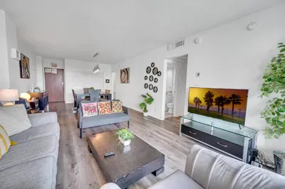 a living room with a large flat screen tv at Spacious 1 BDR 1.5 BTH • Hallandale Beach in Hollywood