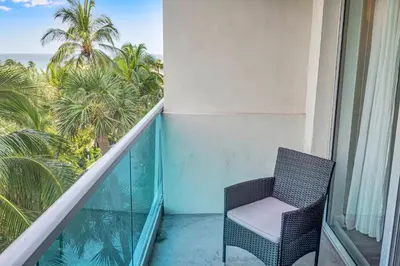 a balcony with a chair and a view of the ocean at Spacious 1 BDR 1.5 BTH • Hallandale Beach in Hollywood