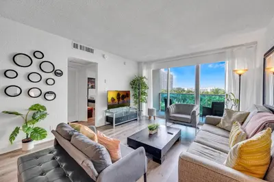 a living room with a couch and a table at Spacious 1 BDR 1.5 BTH • Hallandale Beach in Hollywood