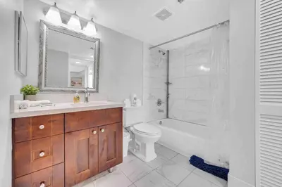a bathroom with a sink and a toilet and a mirror at Beautiful 1 BED 1 BTH • Brickell in Miami