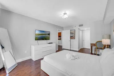 a white bedroom with a white bed and a tv at Beautiful 1 BED 1 BTH • Brickell in Miami