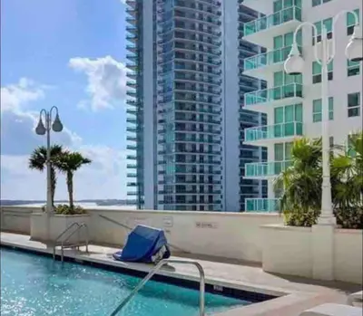 a swimming pool with a view of a tall building at Exquisite 1 Bed • 33 Floor •Brickell • Ocean Views in Miami