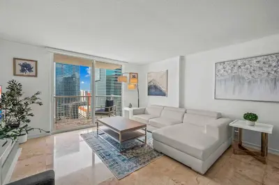 a living room with a couch and a table at Exquisite 1 Bed • 33 Floor •Brickell • Ocean Views in Miami