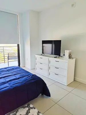 a bedroom with a bed and a tv on a dresser at Stylish 1-Bedroom Getaway Apt- pool & gym in Miami