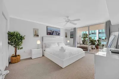 a white bedroom with a white bed and a window at PH 41st Floor 3 BED • Brickell • Ocean View in Miami