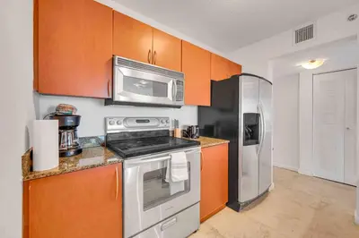 a kitchen with a stove and a microwave at PH 41st Floor 3 BED • Brickell • Ocean View in Miami