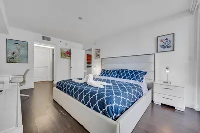 a bedroom with a blue and white bed and a desk at Dazzling 1 BED 1 BTH • Brickell • Bay & City View in Miami