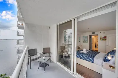 a bedroom with a bed and a view of the water at Dazzling 1 BED 1 BTH • Brickell • Bay & City View in Miami