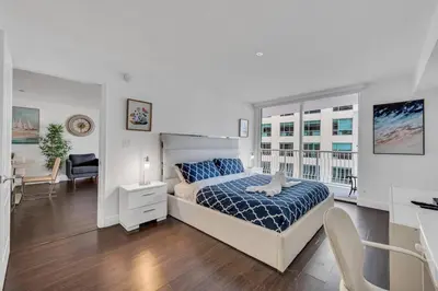 a bedroom with a bed and a desk and a window at Dazzling 1 BED 1 BTH • Brickell • Bay & City View in Miami