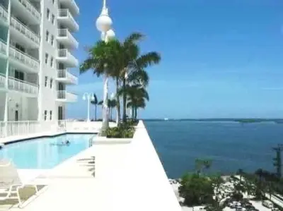 a swimming pool with a view of the ocean at LUX 1 BDR 1 BTH • Brickell • Pool & Ocean Views in Miami