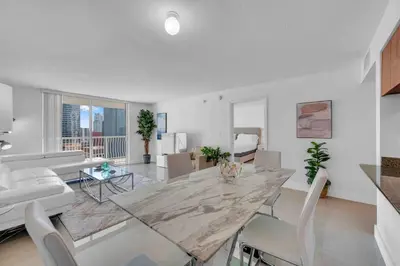 a living room with a large marble table and chairs at Luxe 1 BDR •Brickell• Ocean View in Miami