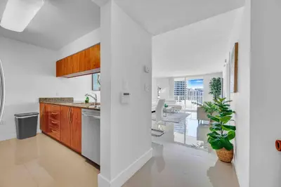 a white kitchen with a sink and a counter at Luxe 1 BDR •Brickell• Ocean View in Miami
