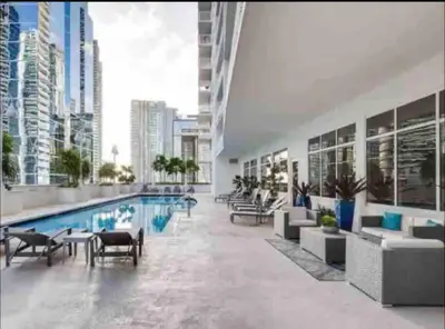 a large building with a swimming pool and a city at Ocean view 1BR Condo Brickell-FreeParking in Miami