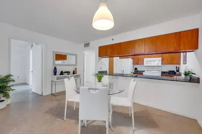 a kitchen and dining room with a table and chairs at Ocean view 1BR Condo Brickell-FreeParking in Miami
