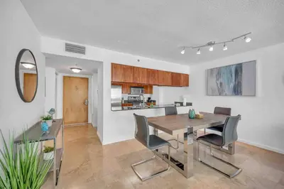 a kitchen and dining room with a table and chairs at Spacious 36th FLR 1 BD 1 BT • Brickell • Bay View in Miami