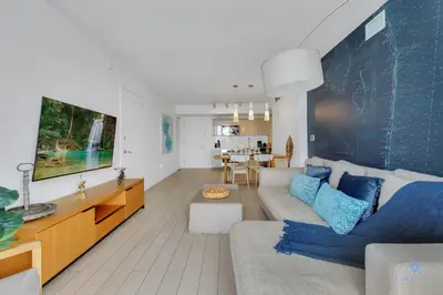 a living room with a couch and a table at Beachwalk Resort infinity Pool Balcony Views in Hallandale Beach
