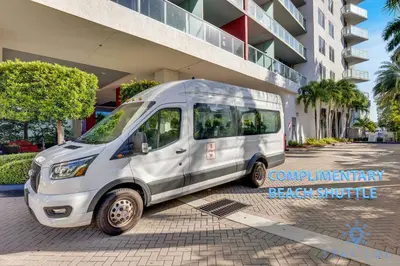 a white van parked in front of a building at Beachwalk Resort infinity Pool Balcony Views in Hallandale Beach