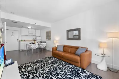 a living room with a couch and a kitchen at 1 Bedroom Jr Suite - Ocean Drive & 6th Str in Miami Beach