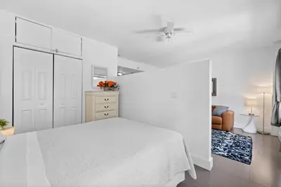 a white bedroom with a white bed and a dresser at 1 Bedroom Jr Suite - Ocean Drive & 6th Str in Miami Beach