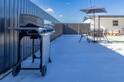 a grill on a patio with a table and chairs at Havana Blue/Pool+Heater/Hard Rock/Gazebo/BBQ in Miami