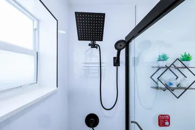 a shower in a bathroom with a black shower head at Havana Blue/Pool+Heater/Hard Rock/Gazebo/BBQ in Miami