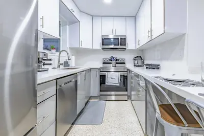 a kitchen with white cabinets and stainless steel appliances at Havana Blue/Pool+Heater/Hard Rock/Gazebo/BBQ in Miami