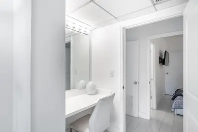 a white bathroom with a sink and a mirror at Sunny Isles Ocean Reserve Condo Apartments in Miami Beach