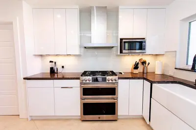 a kitchen with white cabinets and a stove at Amazing Villa WALK 5 minutes to Hollywood Beach in Hollywood
