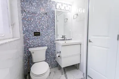 a bathroom with a toilet and a sink and a mirror at Luxury Villa 5BR and 3BR in Hollywood Lakes near Beach in Hollywood