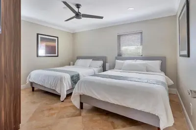 a bedroom with two beds and a ceiling fan at Luxury Villa 5BR and 3BR in Hollywood Lakes near Beach in Hollywood