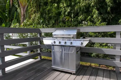 a grill sitting on a deck on a fence at Luxury Villa 5BR and 3BR in Hollywood Lakes near Beach in Hollywood