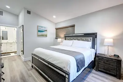 a bedroom with a large bed and a bathroom at Walk to Beach Luxury 4BR & 4BA Villa Hollywood Lakes in Hollywood