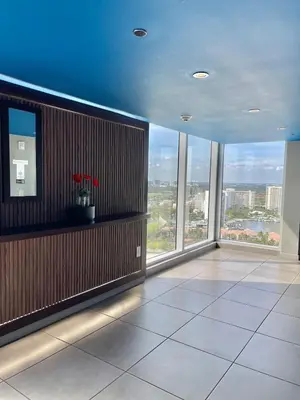 an empty room with large windows in a building at Beachwalk -1 Bedroom With Kitchen Pool And Gym in Hallandale Beach