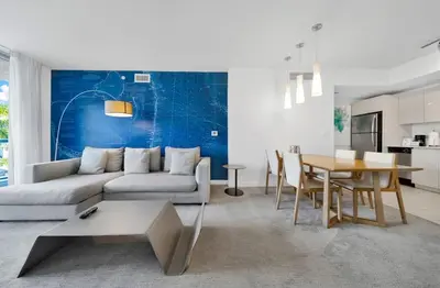 a living room with a couch and a table at Beachwalk -1 Bedroom With Kitchen Pool And Gym in Hallandale Beach