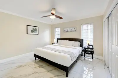 a bedroom with a bed and a ceiling fan at Breathtaking 5BR & 3BA Villa near Hollywood Beach in Hollywood