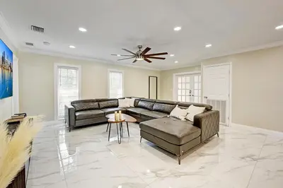 a living room with a couch and a ceiling fan at Breathtaking 5BR & 3BA Villa near Hollywood Beach in Hollywood