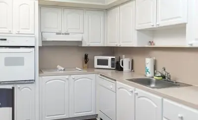 a white kitchen with a sink and a microwave at Komffy Apt w/2 Queen Beds & Canal View at Tides in Hollywood