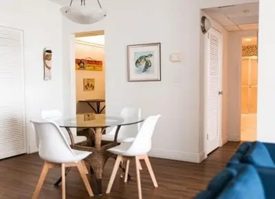 a dining room with a table and white chairs at Komffy Apt w/2 Queen Beds & Canal View at Tides in Hollywood