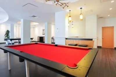 a pool table in the middle of a room at Komffy Apt w/2 Queen Beds & Canal View at Tides in Hollywood